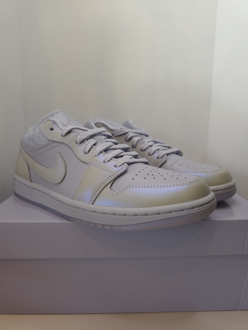 Nike Women's Air Jordan 1 Low SE in the "Ghost"featuring a pearlized Finish.